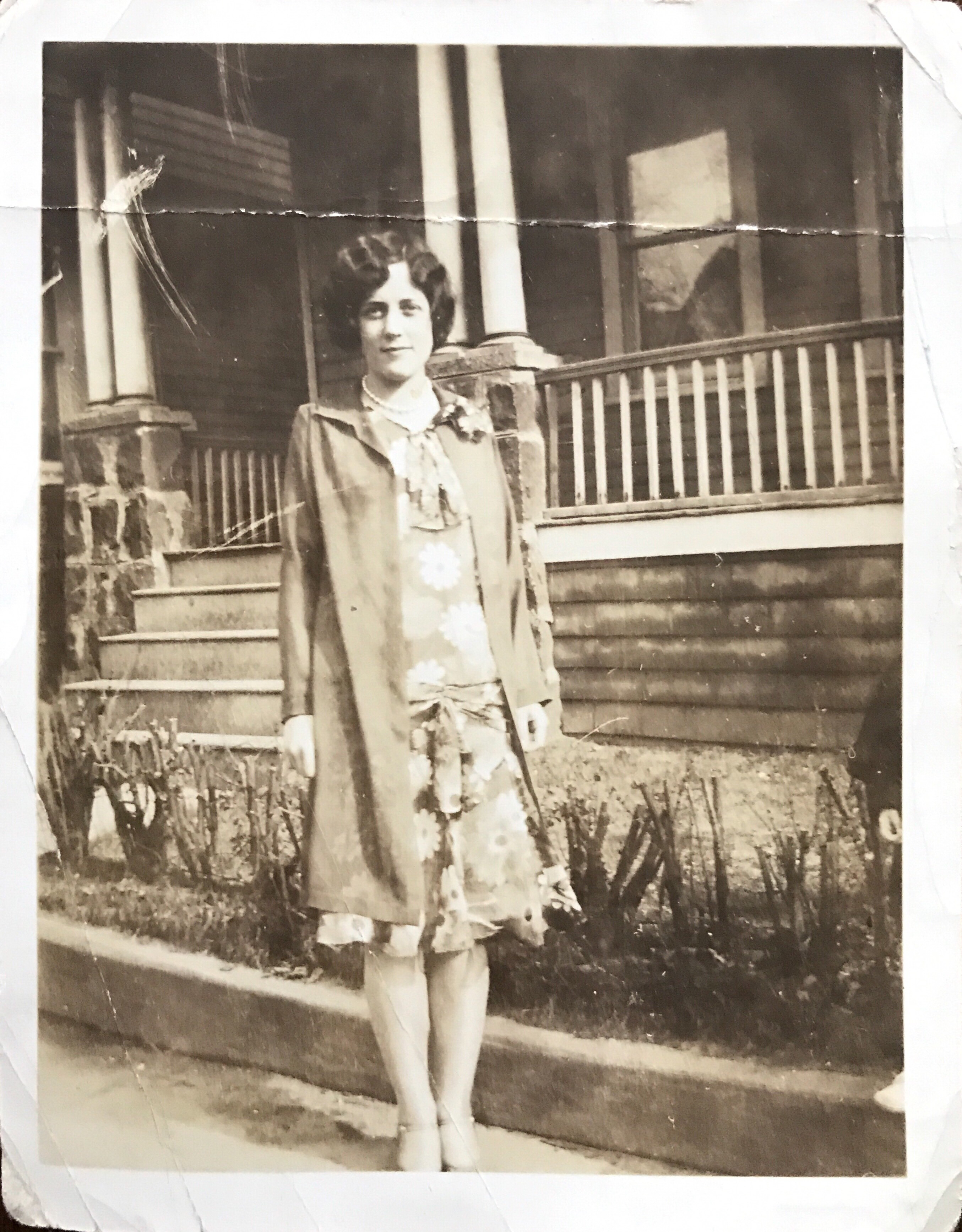 1989 Jean Bronson standing outside house